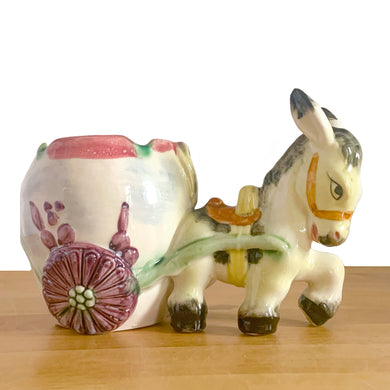 Adorable vintage figural colourful ceramic planter featuring a donkey pulling a cart finished, featuring flower-shaped wheels. Crafted in Japan and marked S3364. Perfect for your favourite houseplant, succulent or repurpose as a pen/pencil or make-up brush holder.   In excellent condition, free from chips/cracks/repairs.  Measures 7 x 4 x 5 inches