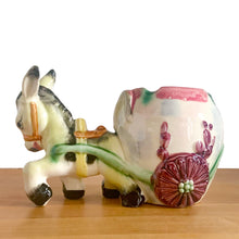 Load image into Gallery viewer, Adorable vintage figural colourful ceramic planter featuring a donkey pulling a cart finished, featuring flower-shaped wheels. Crafted in Japan and marked S3364. Perfect for your favourite houseplant, succulent or repurpose as a pen/pencil or make-up brush holder.   In excellent condition, free from chips/cracks/repairs.  Measures 7 x 4 x 5 inches
