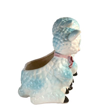 Load image into Gallery viewer, Adorable and rare, anthropomorphic hand painted pale blue double lamb planter with each lamb wearing a pink bow. Crafted by ARCO, Japan, 1950s. A sweet kitschy addition for your new addition. Use for tiny plants or repurpose to hold baby accessories.

In excellent as found vintage condition, no chips/cracks/repairs, normal crazing present.

Measures 5 1/2 x 4 3/4 x 6 inches
