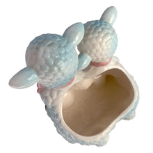 Load image into Gallery viewer, Adorable and rare, anthropomorphic hand painted pale blue double lamb planter with each lamb wearing a pink bow. Crafted by ARCO, Japan, 1950s. A sweet kitschy addition for your new addition. Use for tiny plants or repurpose to hold baby accessories.

In excellent as found vintage condition, no chips/cracks/repairs, normal crazing present.

Measures 5 1/2 x 4 3/4 x 6 inches
