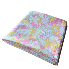 Load image into Gallery viewer, Vintage Dream Garden flat twin sheet featuring a flower power pattern in shades of pink, yellow, green and white. 50% polyester / 50% cotton. Crafted by St. Mary’s, USA, 1970/71. A beautiful addition to your retro boho bedding decor, or repurpose for crafting.

In as found vintage condition.

Sheet #1 has one small hole and a 2-1/2 inch tear near the bottom of the sheet that been poorly mended.

Sheet #2 has two small holes. Please see photos.

Measures 72 x 104 inches
