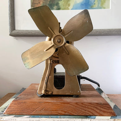 A unique find that we have the privilege to offer is this antique Electrohome Air Conditioner Fan. This heavy metal fan has been mounted on a beveled wood plinth along with its controller box. The box itself is a piece of art with its art deco style graphics in bronze. Manufactured by Dominion Electrohome Industries, Canada, circa  mid-1930s. They were the largest Canadian maker of electric fans. A fabulous piece of Canadian manufacturing history....and it still works great!!!