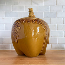 Load image into Gallery viewer, vintage cookie jar of figural elephant features a turbin wearing gentleman sitting on a pillow riding on top which forms the lid&#39;s finial. adorable and the expression on the rider&#39;s face is sassy! The elephant is beautifully decorated in an East Indian motif. Crafted by Noritake, Japan for Giftcraft export. In outstanding condition, free from chips/cracks/wear. We believe this is new old stock. Original sticker present and the bottom has the stamped maker&#39;s mark. Measures 7 1/2 x 5 1/2 x 9 3/4 inches
