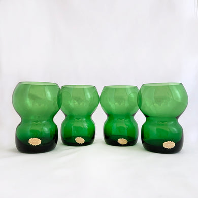 Funky set of four vintage emerald green hand blown glass tumblers. Crafted in Poland, circa 1960s. These glasses feature a bloated hourglass shape. Guaranteed to amp up your bar cart! In excellent condition, free from chips/wear. Original sticker present on each glass, marked 
