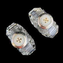 Load image into Gallery viewer, Enhance your tablescape with sparkling vintage brilliant fine cut crystal fan-shaped salt and peppers shakers topped with sterling silver lids inlaid with mother-of-pearl....stunning!

The crystal is in excellent condition, no chips. The sterling silver lids show age related wear. Marked Sterling 925 with hallmark.

Measures 2 x 4 1/2 inches
