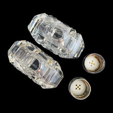 Load image into Gallery viewer, Enhance your tablescape with sparkling vintage brilliant fine cut crystal fan-shaped salt and peppers shakers topped with sterling silver lids inlaid with mother-of-pearl....stunning!

The crystal is in excellent condition, no chips. The sterling silver lids show age related wear. Marked Sterling 925 with hallmark.

Measures 2 x 4 1/2 inches
