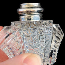 Load image into Gallery viewer, Enhance your tablescape with sparkling vintage brilliant fine cut crystal fan-shaped salt and peppers shakers topped with sterling silver lids inlaid with mother-of-pearl....stunning!

The crystal is in excellent condition, no chips. The sterling silver lids show age related wear. Marked Sterling 925 with hallmark.

Measures 2 x 4 1/2 inches
