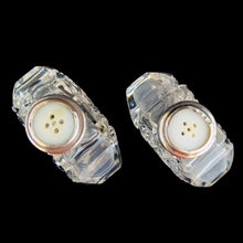 Load image into Gallery viewer, Enhance your tablescape with sparkling vintage brilliant fine cut crystal fan-shaped salt and peppers shakers topped with sterling silver lids inlaid with mother-of-pearl....stunning!

The crystal is in excellent condition, no chips. The sterling silver lids show age related wear. Marked Sterling 925 with hallmark.

Measures 2 x 4 1/2 inches
