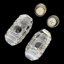 Load image into Gallery viewer, Enhance your tablescape with sparkling vintage brilliant fine cut crystal fan-shaped salt and peppers shakers topped with sterling silver lids inlaid with mother-of-pearl....stunning!

The crystal is in excellent condition, no chips. The sterling silver lids show age related wear. Marked Sterling 925 with hallmark.

Measures 2 x 4 1/2 inches
