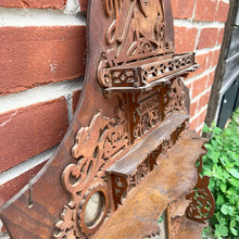 Load image into Gallery viewer, Incredible primitive antique Father Time handmade wood scroll saw wall hung shelf depicting the months of the year with scenes of figures, flora and fauna including birds, rabbits and flowers depicting an activity appropriate to the month, topped with a lounging Father Time with sycthe and hourglass. There are a total of 10 shelves which are notched together and removable, in addition there are 4 mirrors.  In as found condition with a corder of the backboard damaged.
