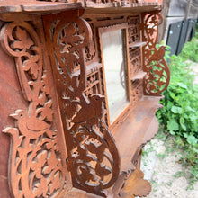 Load image into Gallery viewer, Incredible primitive antique Father Time handmade wood scroll saw wall hung shelf depicting the months of the year with scenes of figures, flora and fauna including birds, rabbits and flowers depicting an activity appropriate to the month, topped with a lounging Father Time with sycthe and hourglass. There are a total of 10 shelves which are notched together and removable, in addition there are 4 mirrors.  In as found condition with a corder of the backboard damaged.
