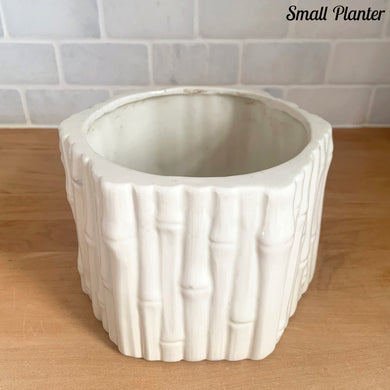 Vintage Hollywood Regency white ceramic faux bamboo hexagonal planter. Circa 1950s. Add a touch of glam to your decor with these unique planters.

Small planter measures 6 x 4 1/2 inches, flea bite to the interior rim, no cracks.