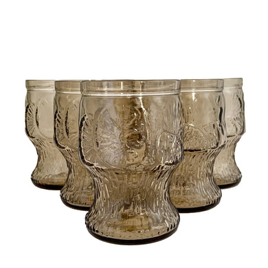 These vintage smokey brown glass tumblers feature an embossed floral and fruit pattern. Set of 6. Crafted by Fidenza Vetraria, Italy, circa 1970s.  In excellent condition, free from chips.  Measures 2 3/4 x 4 3/8 inches