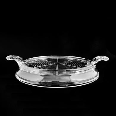 Protect your tables from burns with this vintage Fire-King clear pressed glass trivet. With its decorative handles and Anchor Hocking USA craftsmanship, you'll enjoy supreme heat protection without sacrificing style. Circa 1940s.  In excellent condition, free from chips.  Measures (w/handles) 10 1/4 x 1 3/4 inches