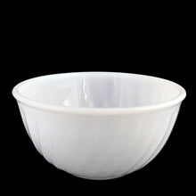 Load image into Gallery viewer, Angled three-quarter view of vintage Anchor Hocking Fire-King Swirl white milk glass mixing bowl showing the open interior, smooth white finish, swirl exterior ribbing, and rolled rim, 7 inches
