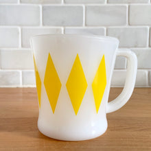 Load image into Gallery viewer, Highly collectible vintage Fire-King Ware milk glass mug with turquoise diamonds, D-handle. Crafted by Anchor Hocking, USA, 1960s. A must-have for any Fire-King collector!

In excellent condition, no chips, cracks or repairs. Paint is vibrant and shiny.

Measures 3 1/4 x 3 3/8 inches
