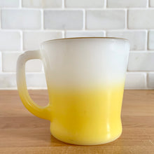 Load image into Gallery viewer, Highly collectible vintage Fire-King Ware milk glass mug with yellow fade and gold rim, D-handle. Crafted by Anchor Hocking, USA, 1960s. A must-have for any Fire-King collector!

In excellent condition, no chips, cracks or repairs. Paint is vibrant and shiny.

Measures 3 1/4 x 3 3/8 inches
