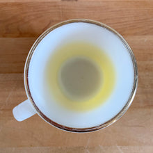 Load image into Gallery viewer, Highly collectible vintage Fire-King Ware milk glass mug with yellow fade and gold rim, D-handle. Crafted by Anchor Hocking, USA, 1960s. A must-have for any Fire-King collector!

In excellent condition, no chips, cracks or repairs. Paint is vibrant and shiny.

Measures 3 1/4 x 3 3/8 inches
