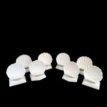 Load image into Gallery viewer, Front view of eight glazed white ceramic clam shell place card holders from Fitz &amp; Floyd's Oceana collection
