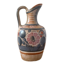 Load image into Gallery viewer, A stunning example of vintage Tonala folk art pottery, this unique hand painted pitcher or jug features whimsical floral and fauna in shades of burnt orange, rose and charcoal gray on a tan ground. Signed MEXICA 1960s era. A beautiful one-of-a-kind piece to enhance your home&#39;s decor!


In good vintage condition, no chips/cracks/repairs, age-related wear/patina.

Measures approximately 6 x 6 x 13 3/8 inches
