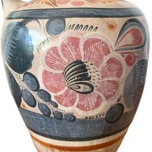 Load image into Gallery viewer, A stunning example of vintage Tonala folk art pottery, this unique hand painted pitcher or jug features whimsical floral and fauna in shades of burnt orange, rose and charcoal gray on a tan ground. Signed MEXICA 1960s era. A beautiful one-of-a-kind piece to enhance your home&#39;s decor!


In good vintage condition, no chips/cracks/repairs, age-related wear/patina.

Measures approximately 6 x 6 x 13 3/8 inches
