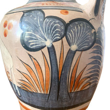 Load image into Gallery viewer, A stunning example of vintage Tonala folk art pottery, this unique hand painted pitcher or jug features whimsical floral and fauna in shades of burnt orange, rose and charcoal gray on a tan ground. Signed MEXICA 1960s era. A beautiful one-of-a-kind piece to enhance your home&#39;s decor!


In good vintage condition, no chips/cracks/repairs, age-related wear/patina.

Measures approximately 6 x 6 x 13 3/8 inches
