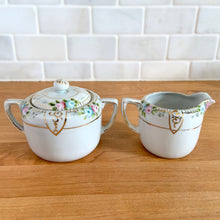 Load image into Gallery viewer, Rear view of Vintage Nippon hand-painted floral creamer and lidded sugar bowl set
