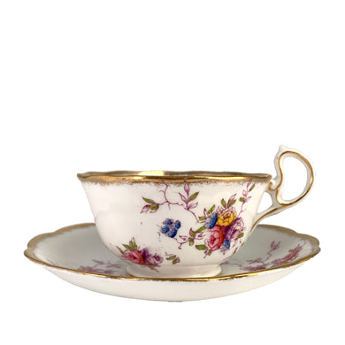 Vintage pattern 2349 fine bone china teacup and saucer featuring hand painted flowers in shades of pink, purple, blue, yellow and green with brush gold gilt trim. Crafted by Royal Albert Crown China, England, 1917-25. A lovely way to enjoy a cuppa tea!

In excellent condition, no chips, cracks or repairs. Maker's mark on the bottom.

Measures 4 x 2 3/8 inches | Saucer measures 5 1/2 inches