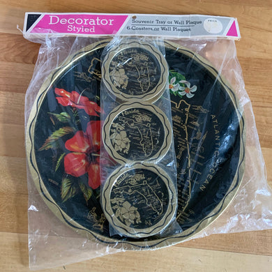 Vintage Florida souvenir black and gold metal tray and coaster set featuring a red hibiscus and white orchid flower alongside a gold map of Florida. The perfect addition to your tropical or tiki barware collection!  In excellent condition, new in package.  Tray measures 10 7/8 inches  Coasters measure 3 1/2 inches