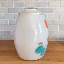 Load image into Gallery viewer, Vintage mid-century white glass lidded canister or cookie jar hand painted with flowers and fruits. Crafted by Bartlett Collins, 1960s. A nice sized and pretty jar to store cookies or dry goods.

In excellent condition, no chips, minor wear to the gold.

Measures 7 x 9 1/2 inches
