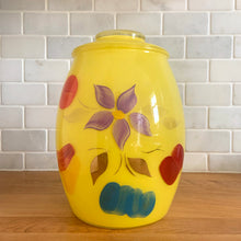 Load image into Gallery viewer, Vintage mid-century yellow glass lidded canister or cookie jar hand painted with flowers and fruits. Crafted by Bartlett Collins, 1960s. A nice sized and pretty jar to store cookies or dry goods.

In good vintage condition, no chips, age-related wear to the gold.

Measures 7 x 9 1/2 inches
