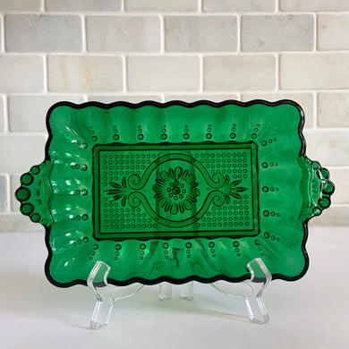 Vintage forest green 8 inch rectangular relish dish featuring a central medallion, scalloped rim and handles. Crafted by Anchor Hocking, USA, 1957 - 1965. A sweet dish to add charm to your tablescape.

In excellent condition, no chips.

Measures 8 1/4 x 4 3/4 x 1 inch