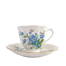 Load image into Gallery viewer, Vintage Avon shaped Forget-Me-Not bone china teacup and saucer, features a scalloped edge with hand painted blue flowers and gold gilt rim. Royal Albert, England, 1950s.  In excellent condition, free from chips, cracks and repairs. Makers marks present.  Teacup measures 3 1/4 x 2 3/4 inches | Saucer measures 5 1/2 inches
