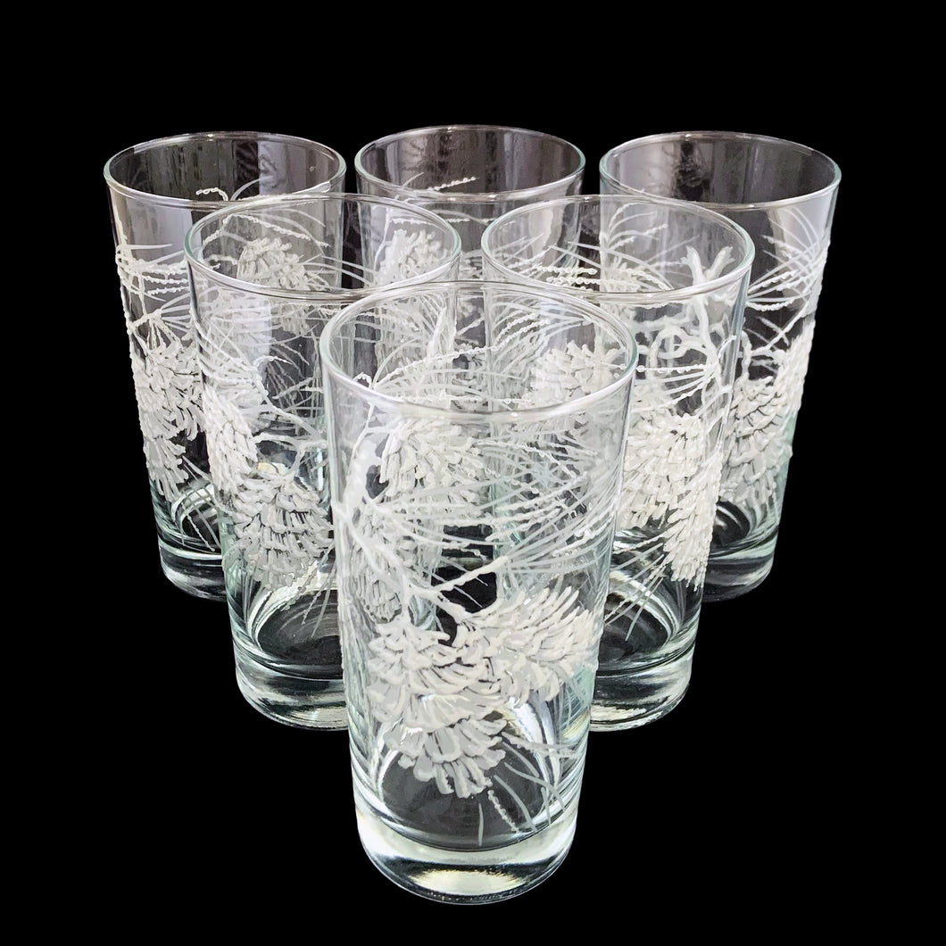 Set of six vintage highball cocktail glasses decorated with raised enamel frosted pinecones that give off a lovely sparkle. Crafted by Libbey St. Clair, USA, 1960s. These glasses are sure to add a festive flare to your Christmas and winter time cocktails!

In excellent condition, no chips.

Measures 2 3/4 x 5 3/8 inches

Capacity 12 ounces