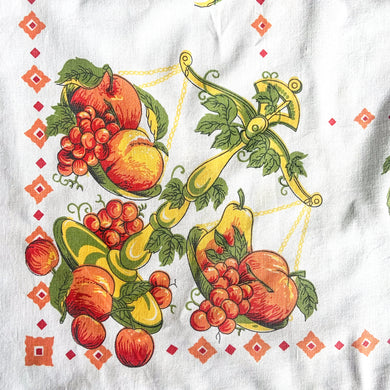 Give your table a vibrant, retro touch with this vintage white cotton tablecloth. Featuring fruits in eye-popping orange, yellow, red, and green, it's sure to be the life of the party! Perfect for adding a hint of nostalgia to any gathering. Wow your guests!  In great vintage condition, free from tears. Minor stain.  Measures 64 x 50 inches   