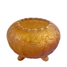 Load image into Gallery viewer, Lovely antique Garland and Bows marigold carnival glass rose bowl featuring an iridescent stipple finish, inward scalloped rim and three scroll feet. Crafted by Fenton Art Glass, 1920s. The bowl shimmers beautifully in the light and is suited to any decor style and has enough vintage sparkle to catch anyone&#39;s eye!

In excellent condition, no chips.

Measures 4 3/4 x 3 3/4 inches

