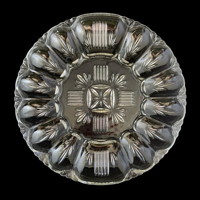 Gorgeous clear pressed glass deviled egg serving plate. Produced by Federal Glass, circa 1950. This plate has a lovely pattern of leaves and bars, space for 12 eggs, condiments and pickles/olives. Perfect for serving this classic appetizer!  In excellent condition, no chips.  Measures 10 3/4 inches