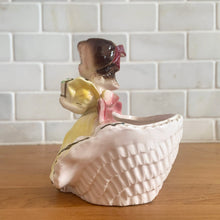 Load image into Gallery viewer, Adorable vintage mid-century era girl in a yellow dress ceramic planter 502. Crafted by Rubens Originals, Japan, 1950s. Use for tiny plants or repurpose to hold accessories.

In as found vintage condition, bow is chipped at the back, no cracks/repairs.

Measures 4 1/2 x 4 x 4 1/2 inches
