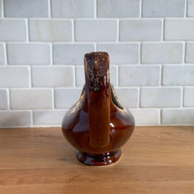 Load image into Gallery viewer, Vintage glossy brown drip glazed ceramic handled gravy boat. Crafted by Hull Pottery, USA, 1960s. A beautiful piece to add to your art pottery tableware collection!

In excellent condition, no chips/cracks/repairs. Maker&#39;s marks.

Measures 10 3/8 x 4 1/4 x 5 5/8 inches
