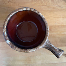 Load image into Gallery viewer, Vintage glossy brown drip glazed ceramic handled soup serving bowl. Crafted by Hull Pottery, USA, 1960s. A beautiful piece to add to your art pottery tableware collection!

In excellent condition, no chips/cracks/repairs. Maker&#39;s marks.

Measures 8 1/4 x 3 5/8 (12 x 3 5/8 inches with handle)
