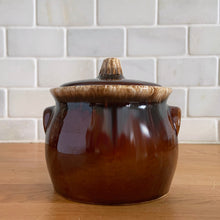 Load image into Gallery viewer, Vintage glossy brown drip glazed covered sugar bowl. Crafted by Hull Pottery, USA, 1960s. A beautiful piece to add to your tableware!

In excellent condition, no chips/cracks/repairs. Maker&#39;s marks.

Measures 4 x 4 1/4 inches
