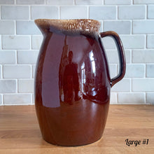 Load image into Gallery viewer, Vintage glossy brown drip glazed ceramic pitcher. Crafted by Hull Pottery, USA, 1960s. A beautiful piece to add to your home decor or art pottery collection!

In excellent condition, no chips/cracks/repairs. Maker&#39;s marks.

Measurements

Large: 5 x 9 inches, 72 ounces
