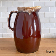 Load image into Gallery viewer, Vintage glossy brown drip glazed ceramic pitcher. Crafted by Hull Pottery, USA, 1960s. A beautiful piece to add to your home decor or art pottery collection!

In excellent condition, no chips/cracks/repairs. Maker&#39;s marks.

Measurements

Large: 5 x 9 inches, 72 ounces
