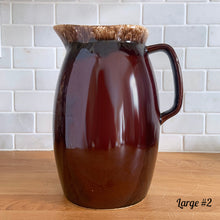 Load image into Gallery viewer, Vintage glossy brown drip glazed ceramic pitcher. Crafted by Hull Pottery, USA, 1960s. A beautiful piece to add to your home decor or art pottery collection!

In excellent condition, no chips/cracks/repairs. Maker&#39;s marks.

Measurements

Large: 5 x 9 inches, 72 ounces
