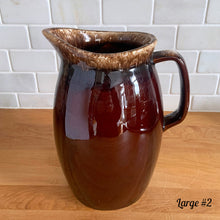 Load image into Gallery viewer, Vintage glossy brown drip glazed ceramic pitcher. Crafted by Hull Pottery, USA, 1960s. A beautiful piece to add to your home decor or art pottery collection!

In excellent condition, no chips/cracks/repairs. Maker&#39;s marks.

Measurements

Large: 5 x 9 inches, 72 ounces
