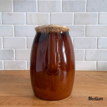 Load image into Gallery viewer, Vintage glossy brown drip glazed ceramic pitcher. Crafted by Hull Pottery, USA, 1960s. A beautiful piece to add to your home decor or art pottery collection!

In excellent condition, no chips/cracks/repairs. Maker&#39;s marks.

Measurements

Medium: 4 x 6 3/4 inches, 32 ounces
