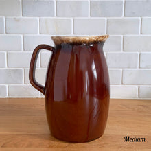 Load image into Gallery viewer, Vintage glossy brown drip glazed ceramic pitcher. Crafted by Hull Pottery, USA, 1960s. A beautiful piece to add to your home decor or art pottery collection!

In excellent condition, no chips/cracks/repairs. Maker&#39;s marks.

Measurements

Medium: 4 x 6 3/4 inches, 32 ounces
