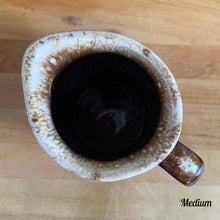 Load image into Gallery viewer, Vintage glossy brown drip glazed ceramic pitcher. Crafted by Hull Pottery, USA, 1960s. A beautiful piece to add to your home decor or art pottery collection!

In excellent condition, no chips/cracks/repairs. Maker&#39;s marks.

Measurements

Medium: 4 x 6 3/4 inches, 32 ounces

