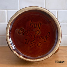 Load image into Gallery viewer, Vintage glossy brown drip glazed ceramic pitcher. Crafted by Hull Pottery, USA, 1960s. A beautiful piece to add to your home decor or art pottery collection!

In excellent condition, no chips/cracks/repairs. Maker&#39;s marks.

Measurements

Medium: 4 x 6 3/4 inches, 32 ounces
