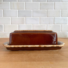 Load image into Gallery viewer, Vintage glossy brown drip glaze covered butter dish. Crafted by Hull Pottery, USA, 1960s. Enjoy this fabulous retro oven-proof tableware!

In excellent condition, no chips/cracks/repairs. Maker&#39;s marks.

Measures 7 3/4x 3 3/8 x 2 inches

Capacity 1/4 pound stick
